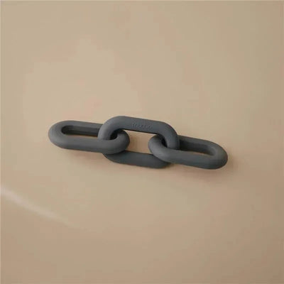 Silicone baby teether toy in a chain link design, colored grey, against a neutral background.