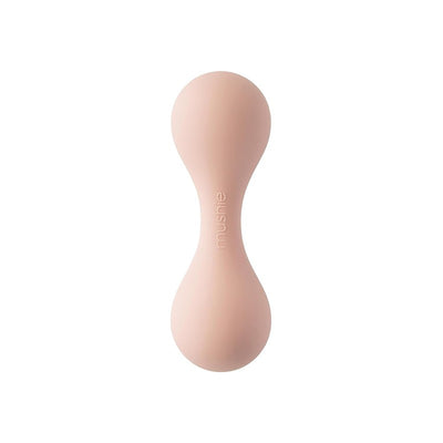 Mushie Silicone Baby Rattle Toy in blush color, featuring a smooth, ergonomic design for easy gripping.
