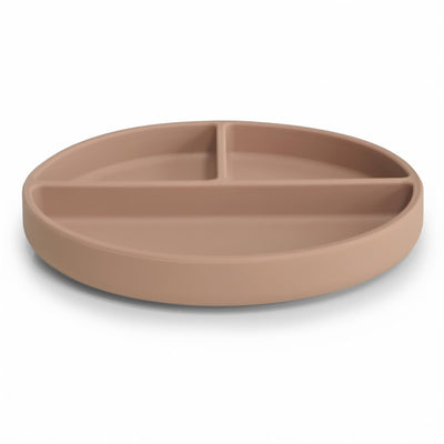 Mushie Silicone Suction Plate in natural color, featuring a round design with three compartments for food.