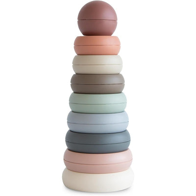 Mushie Stacking Rings in various soft colors, arranged in a pyramid shape, designed for playful stacking and learning.