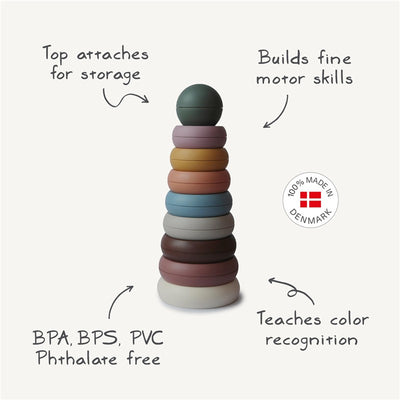 Mushie Stacking Rings in rustic colors, designed to build fine motor skills and teach color recognition; BPA-free.