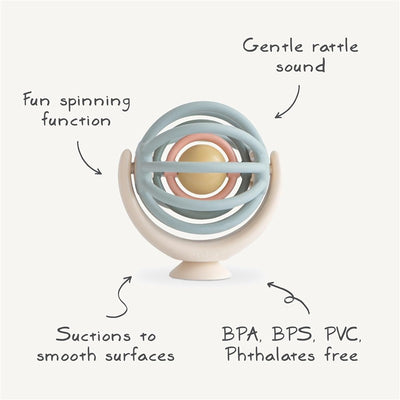 Mushie Suction Spinner Ball in pastel colors, featuring a spinning function, gentle rattle sound, and suction base, BPA free.