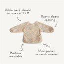 Water-resistant baby bib with a floral pattern, adjustable Velcro neck, elastic sleeves, and a wide pocket for spills.