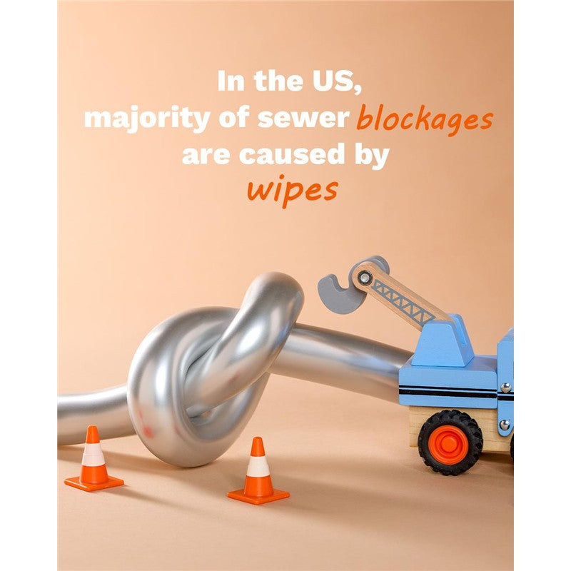 Cleansing water wipes are represented in a playful image featuring a twisted pipe and a toy truck with a crane, emphasizing sewer blockages.