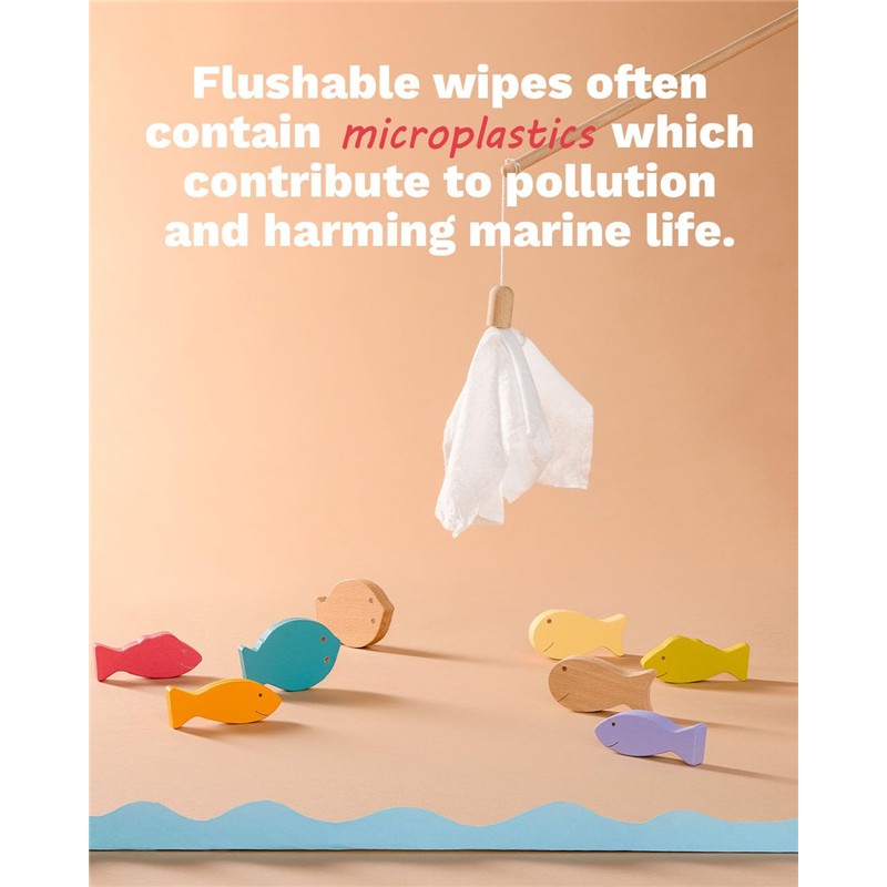 Compostable cleansing wipes hanging from a wooden stick, surrounded by colorful wooden fish, highlighting eco-friendly messaging.
