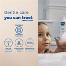 Mustela Gentle Cleansing Gel bottle beside a child in a bath, highlighting gentle care and natural ingredients.