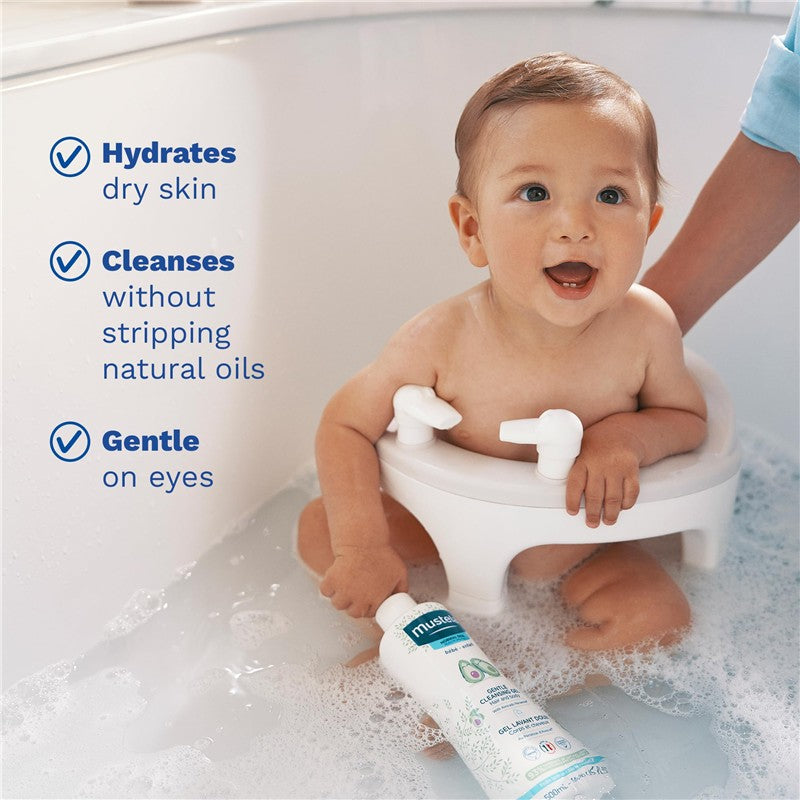 Mustela Gentle Cleansing Gel bottle held by a smiling baby in a bath; features hydration, cleansing, and gentleness claims.