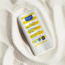 Mustela SPF 50 Mineral Sunscreen Stick, 0.6 oz, featuring a white and yellow package on sandy surface, labeled for face and body.