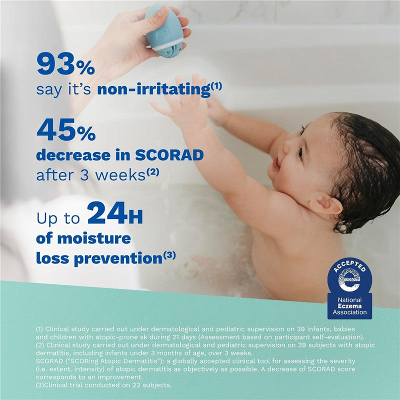 Mustela Stelatopia Cleansing Gel in a blue bottle is being used by an adult in a bath with a smiling baby, highlighting its gentle, non-irritating formula.