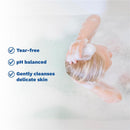 Mustela Stelatopia Foam Shampoo in use, featuring a child washing hair with foam, highlighting tear-free, pH balanced, and gentle cleansing benefits.