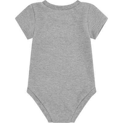Short-sleeved, ribbed baby bodysuit in carbon heather gray, featuring a simple and classic design.