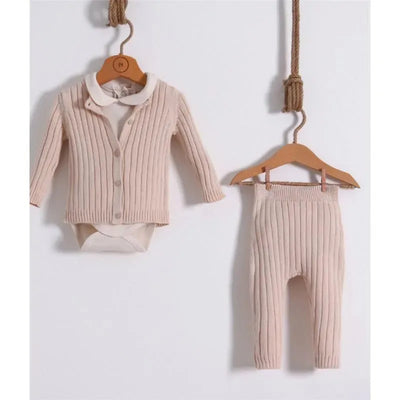 Baby knitted outfit in cream, featuring a ribbed cardigan with a collar and matching ribbed leggings, displayed on wooden hangers.