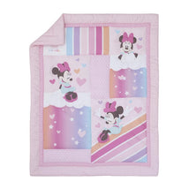 Minnie Mouse themed crib bedding set featuring colorful patches with hearts and playful designs in pink and pastel tones.