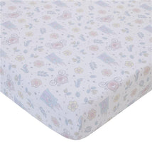Light blue, pink, and white crib sheet with whimsical Cinderella-themed patterns, featuring castles, flowers, and magical items.