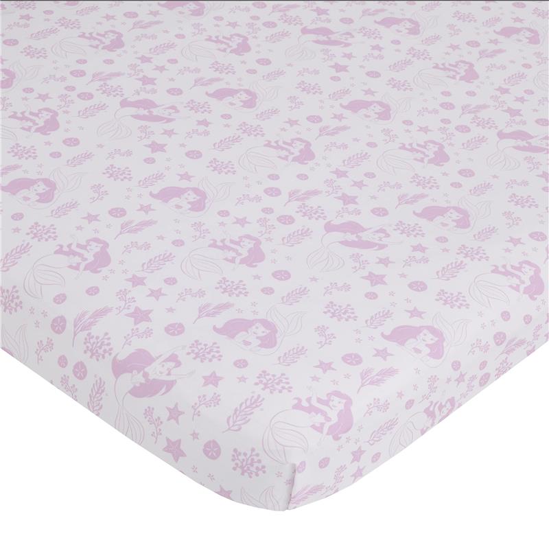 Mini crib bedding set featuring pastel pink Ariel designs, underwater elements, and whimsical patterns suitable for a nursery.