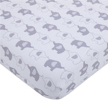 Mini crib bedding set featuring a playful design of gray and white elephants on a soft background.
