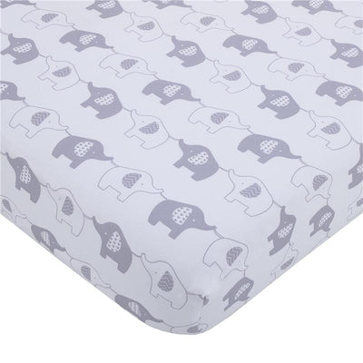 Mini crib bedding set featuring a playful design of gray and white elephants on a soft background.