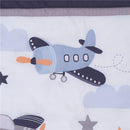 Bedding set featuring a whimsical blue airplane design with clouds and stars, ideal for nursery decor.
