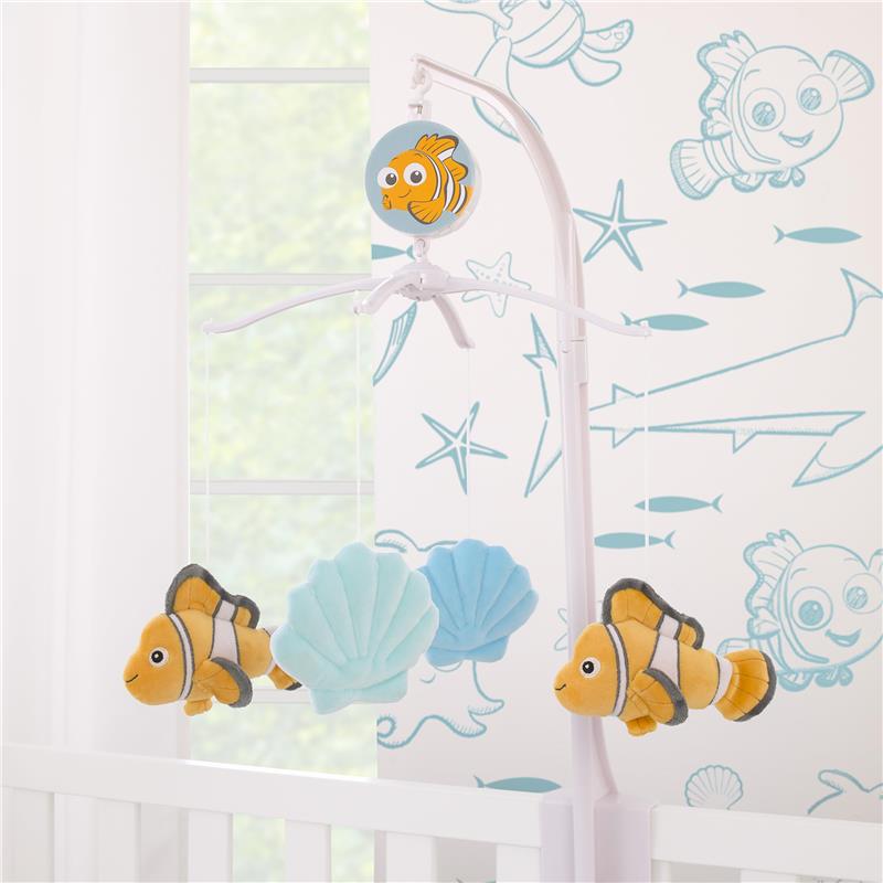 Musical mobile featuring plush Nemo and seashells, designed for nursery decoration.