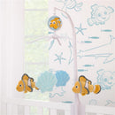 Musical mobile featuring plush Nemo and seashells, designed for nursery decoration.