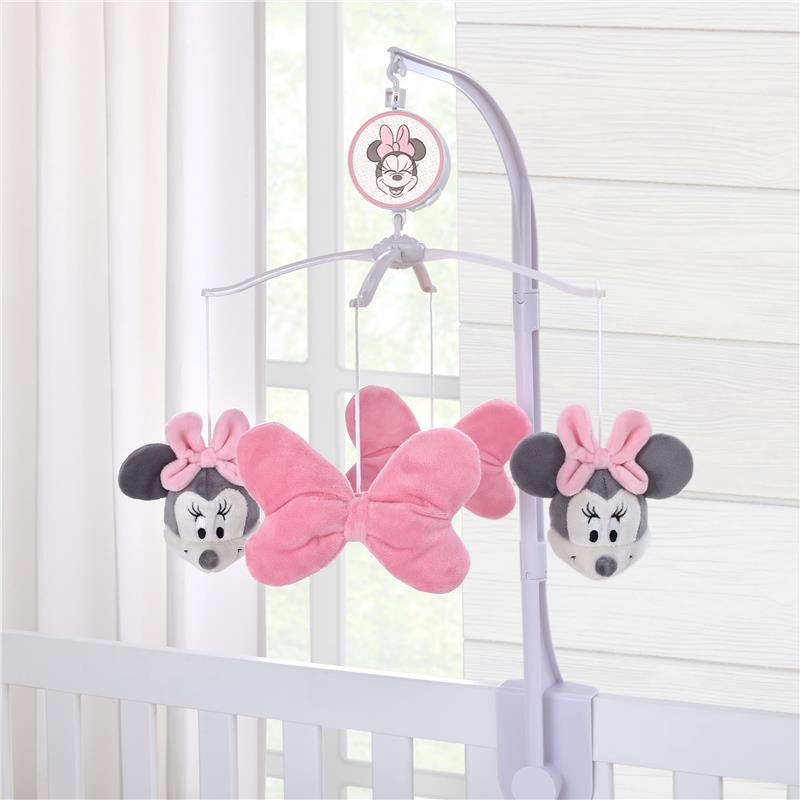 Pink plush Minnie Mouse musical mobile with bows, designed for baby nursery decor, featuring plush characters and soft textures.