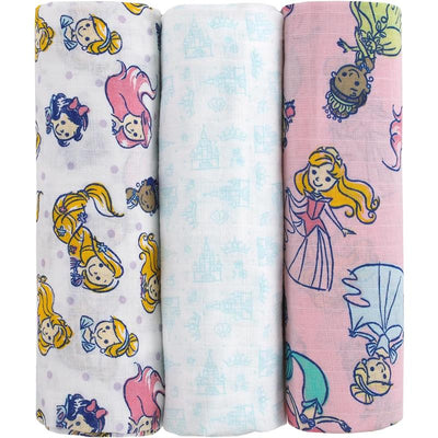 Three printed muslin swaddles featuring princess characters and castle motifs in pink, white, and purple colors.