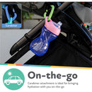 Nuby Clik-It Soft Spout Cup in blue with pink lid, attached via carabiner to a stroller, emphasizing on-the-go hydration.