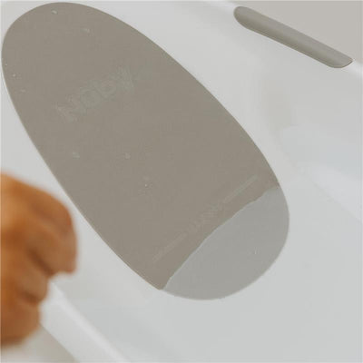 Comfort Baby Bathtub with a gray, water-resistant bath mat featuring the Nuby logo, suitable for infant bathing.