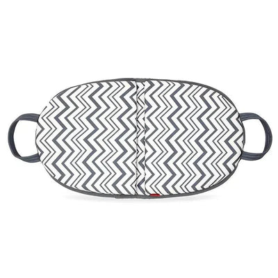 Folding knee pad by Nuby featuring a zigzag black and white design with side handles for easy carrying.
