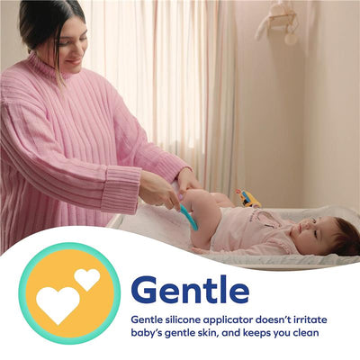 Gentle silicone applicator being used to apply diaper rash cream on a baby, highlighting its ease of use and skin-friendly design.