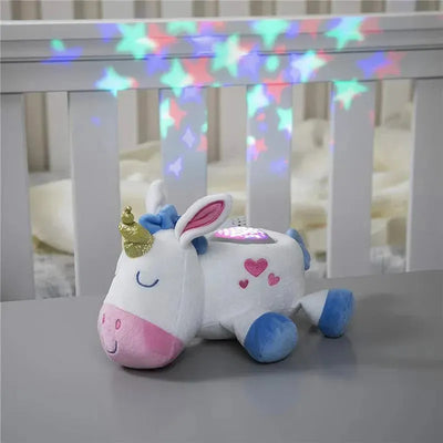 Plush unicorn night light with a golden horn, projecting colorful star patterns onto nearby surfaces.