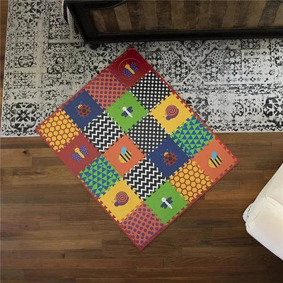 Colorful Nuby Eva Floor Foam Tiles set, featuring various animal and geometric patterns, arranged on a wooden floor.