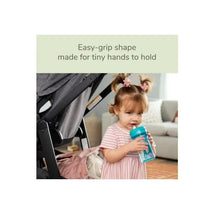 NUK 10 Oz EasyStraw Cup in teal, held by a toddler with playful hair, showcasing an easy-grip design for small hands.