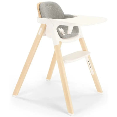 Nuna BRYN High Chair in Heritage style, featuring a white frame, wooden legs, and a cushioned gray seat.