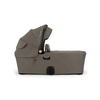 Nuna DEMI™ next Bassinet in Granite color, featuring a sleek design with a foldable canopy and storage pocket.