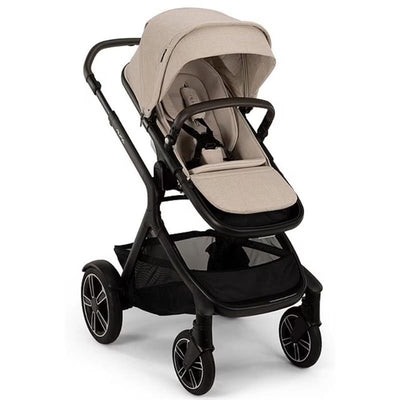 Nuna DEMI™ next Stroller in Biscotti color with a spacious canopy, adjustable seat, and a storage basket below.