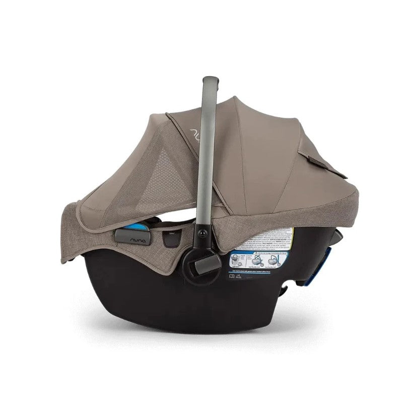 Nuna Pipa Rx infant car seat in cedar color with adjustable canopy and safety features visible on the side.