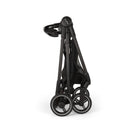 Nuna Flex System Frame in a folded position, featuring black metal frame and wheels, designed for easy transport.