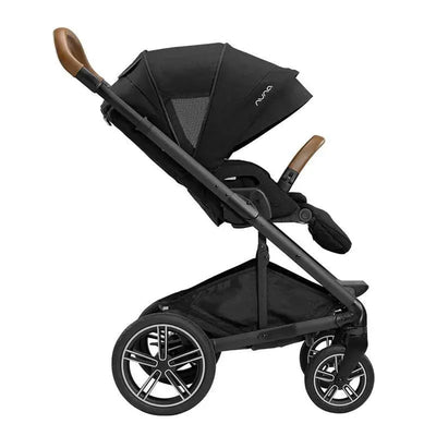 Nuna MIXX™ next stroller in caviar color, featuring a magnetic buckle, adjustable canopy, and brown handle.