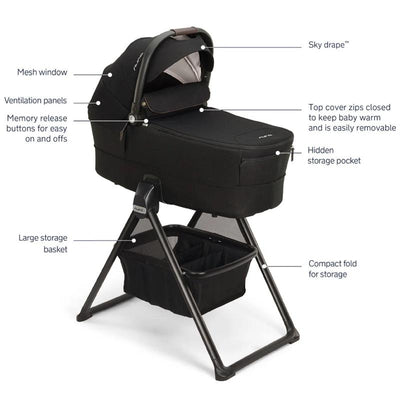 NUNA MIXX Series bassinet in caviar and chocolate, featuring a mesh window, ventilation panels, and large storage basket.