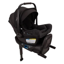 Nuna Pipa Aire Rx infant car seat in Caviar/Chocolate, featuring a removable canopy and safety labels on the base.