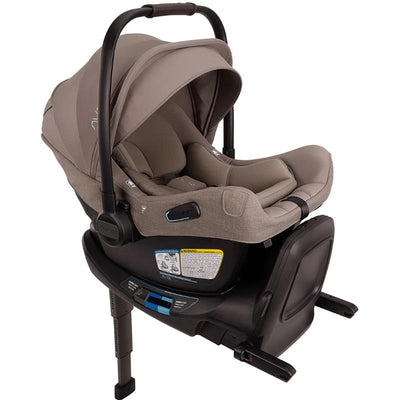 Nuna PIPA™ aire rx Infant Car Seat in Cedar color with a safety harness, adjustable handle, and base features.