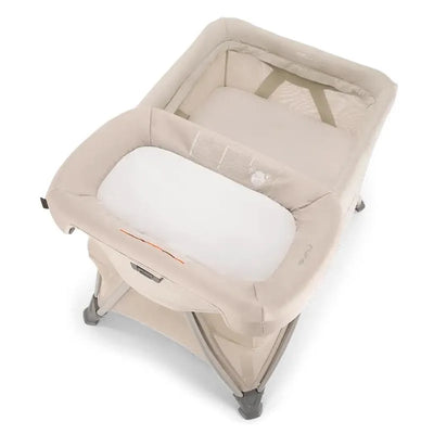 Nuna SENA™ aire playard in Biscotti color featuring a zip-off bassinet and changer with a soft, padded surface.