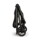 Nuna Swiv stroller, folded and compact, features sleek black design with logo on handle, ideal for travel.