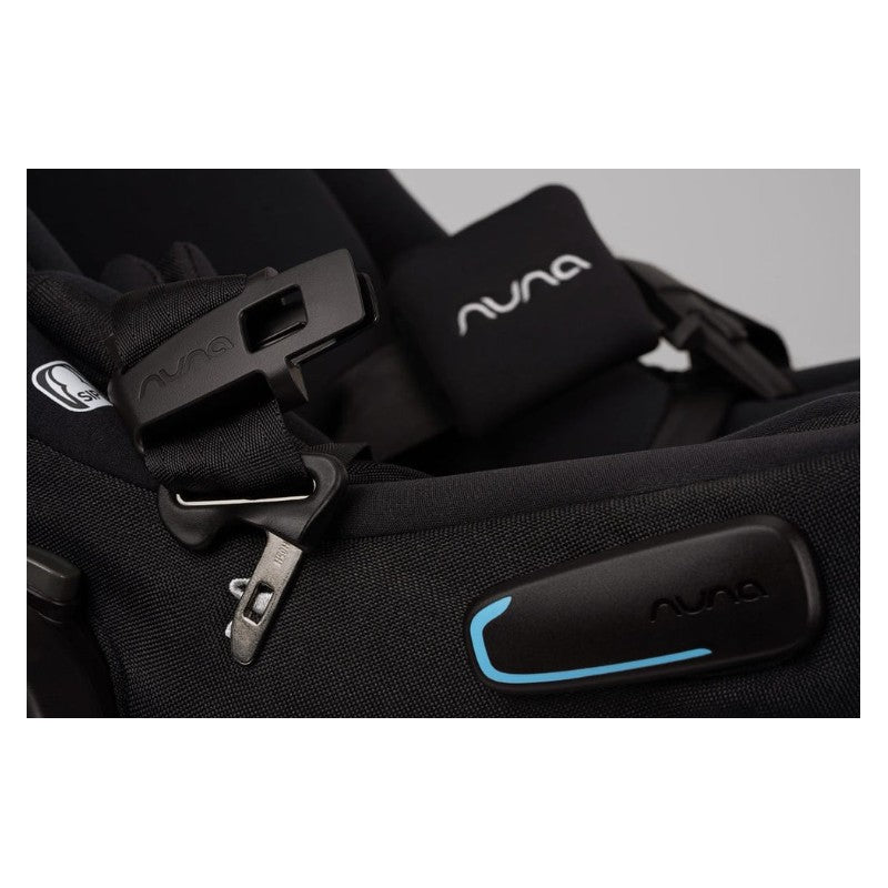 Nuna Swiv + Pipa Aire Rx travel system detail showing harness buckle and branding in black and blue.