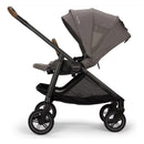 Travel system featuring the Nuna Swiv stroller in granite color with a reclining seat and adjustable canopy.