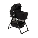 Nuna Swiv Stroller with a Caviar-colored bassinet and stand, featuring a spacious lower storage basket.