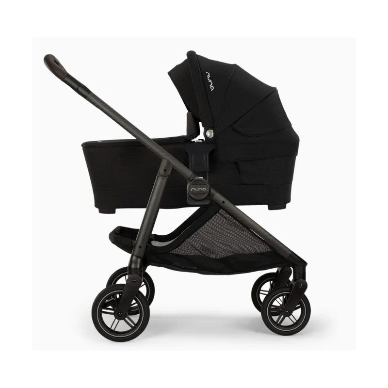 Nuna Swiv stroller with attached bassinet in Caviar - Chocolate color, featuring a sleek design and sturdy wheels.