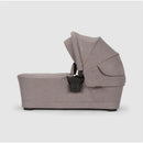 Nuna SWIV & TRIV Series Bassinet in Umber, featuring a zippered side and a foldable canopy for infants.