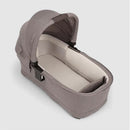 Nuna SWIV & TRIV Series Bassinet in Umber color, featuring a soft inside with a removable liner and adjustable canopy.